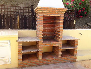 New construction brick barbecue at the pool terrace - Building contractors S-Chavos, Malaga.